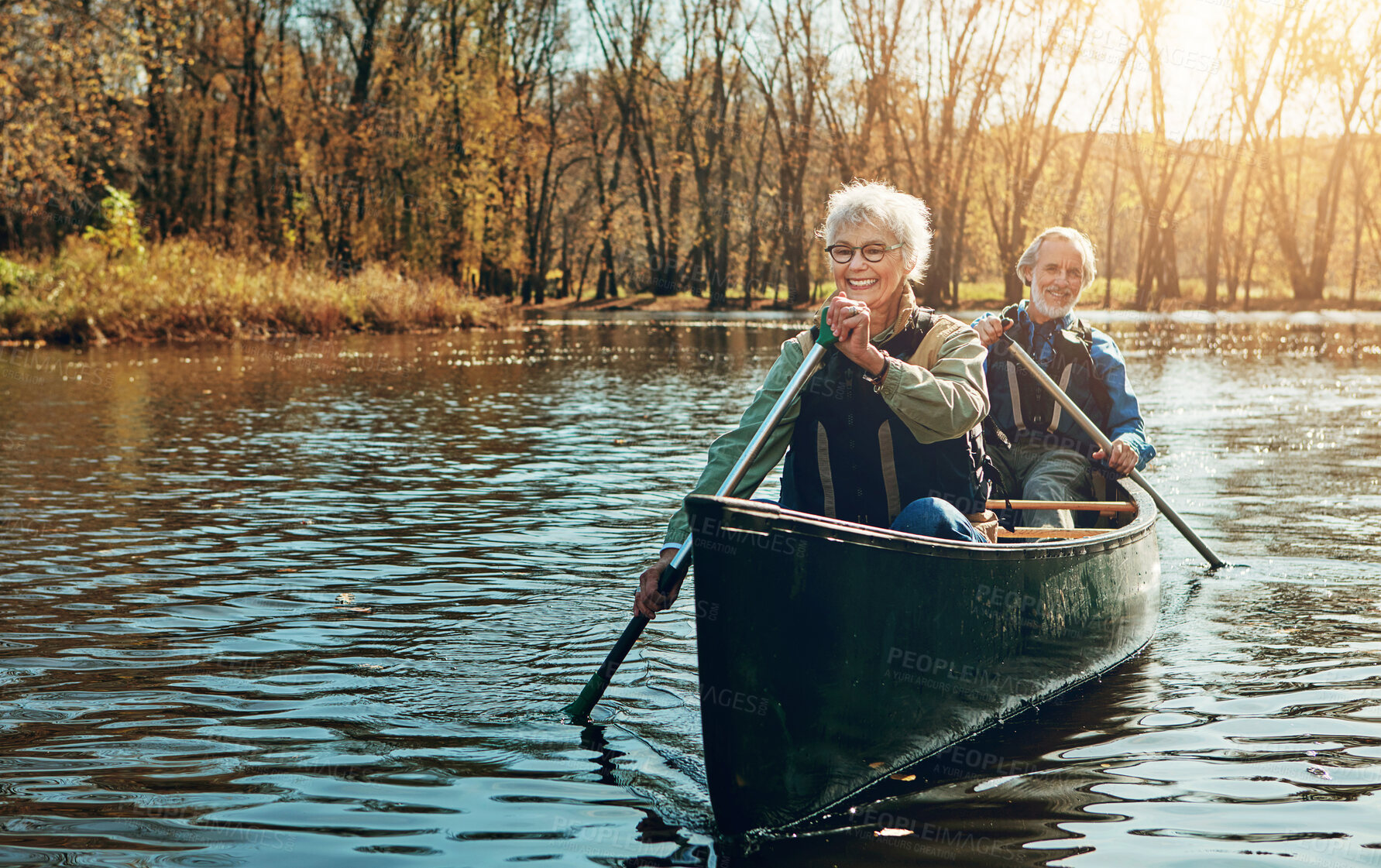 Buy stock photo Lake, sunshine and kayak with old couple, nature and retirement with happiness, getaway trip and vacation. Outdoor, river and mature man with senior woman, rowing and trust with holiday and romance