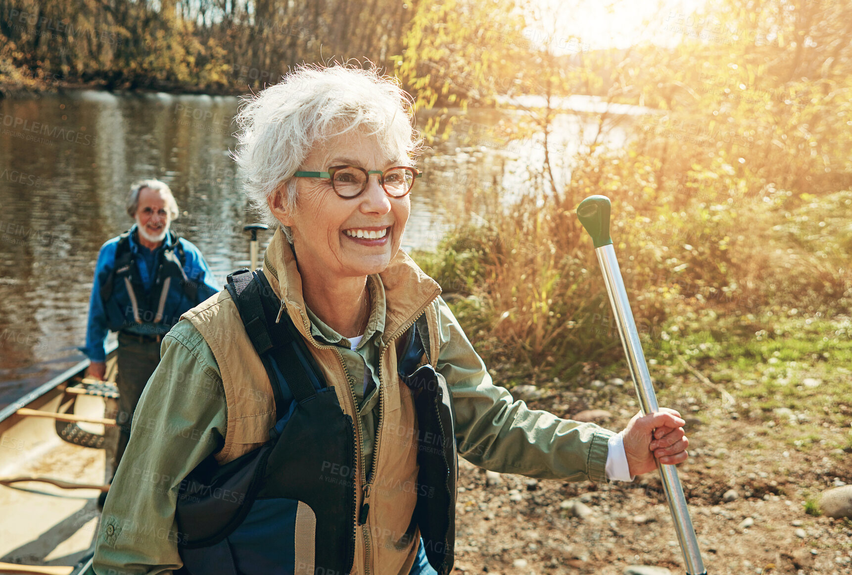 Buy stock photo Senior woman, man and kayak adventure on lake in nature, freedom or travel for wellness. Happy couple, river and getting out of boat for walk in forest, vacation or holiday for retirement lifestyle