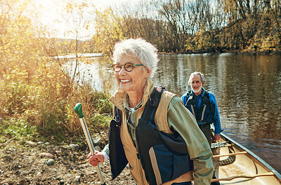 Buy stock photo Senior woman, man and kayak adventure on river in nature, freedom or travel for wellness. Happy couple, lake and getting out of boat for walk in forest, vacation or holiday for retirement lifestyle