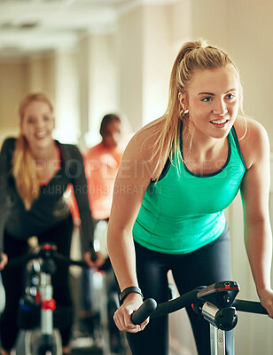 Buy stock photo Fitness, cycling and girl at a gym with bike machine for training, wellness and morning cardio together. Spinning class, exercise and people at a sports studio for workout, challenge or performance