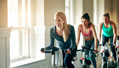 Buy stock photo People, exercise bike and gym for cardio, training and cycling for fitness or spin class. Women, riding and stationary machine for workout challenge, aerobic instructor and equipment for practice