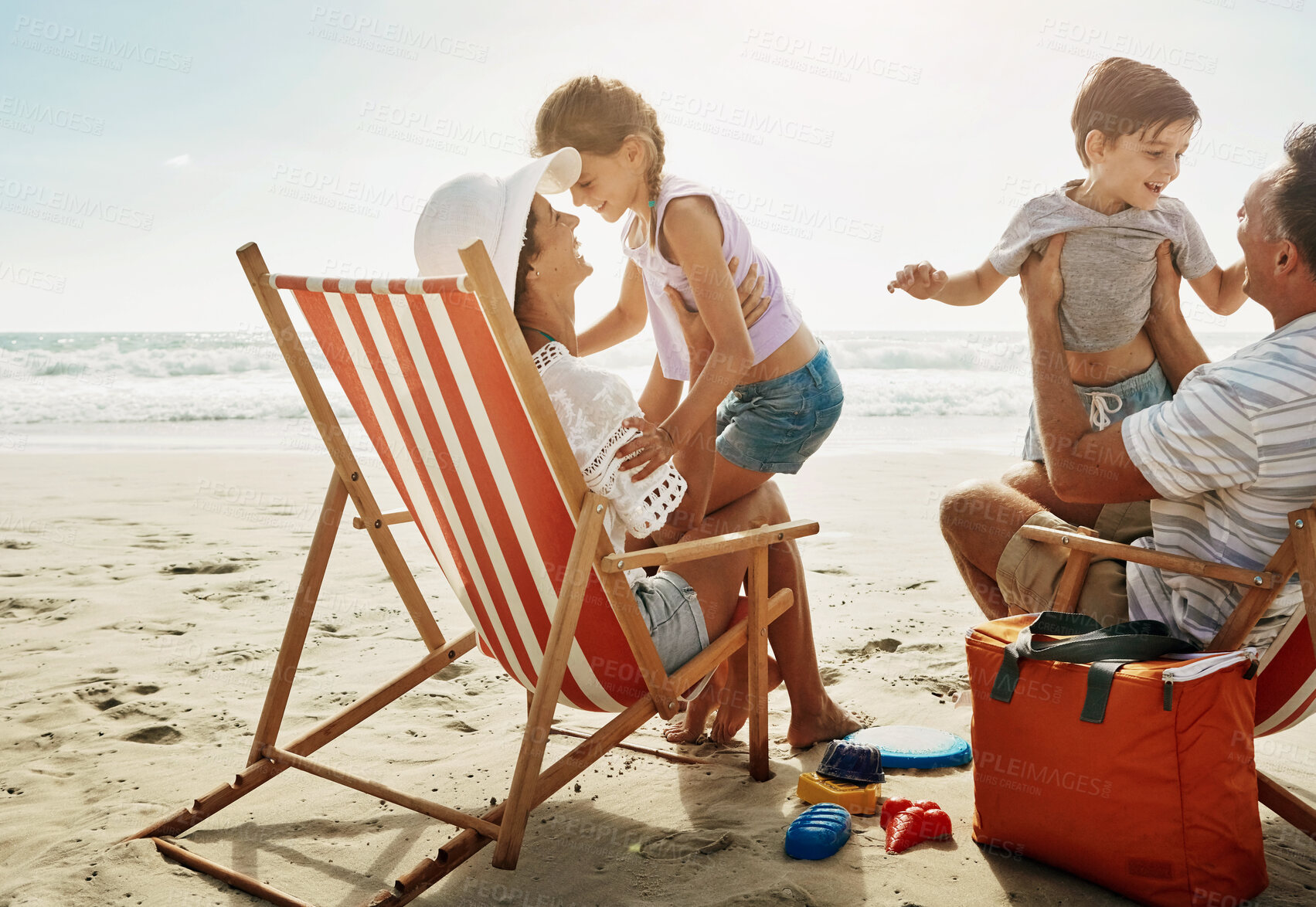 Buy stock photo Family, chairs and beach fun with happy people, children and parents together on vacation for bonding. Mother, father and love or relaxing on tropical holiday, wellness break and smile outside