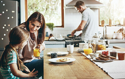 Buy stock photo Juice, breakfast pancakes and happy family with children, mother and father, bonding and prepare ingredients. Morning food, cooking and hungry woman, man and daughter in home kitchen eating meal