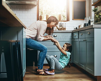 Buy stock photo Happy, woman and kid with playing in kitchen for weekend fun, care and support in childhood. Love, smile and mom with little girl at family home for funny bonding, humor and joy in motherhood