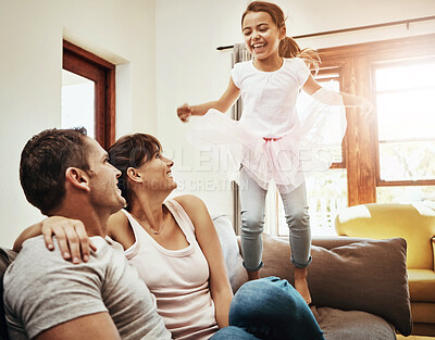 Buy stock photo Happy, parents, and girl playing on sofa for fun with support, care and love in living room. Home, smile and family together with kid with tutu skirt on couch for bonding, growth or child development