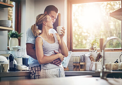 Buy stock photo Coffee, hug and love with couple in kitchen of home together for morning break or wellness. Cup, smile or tea with happy man and woman drinking fresh beverage in apartment for love or romance