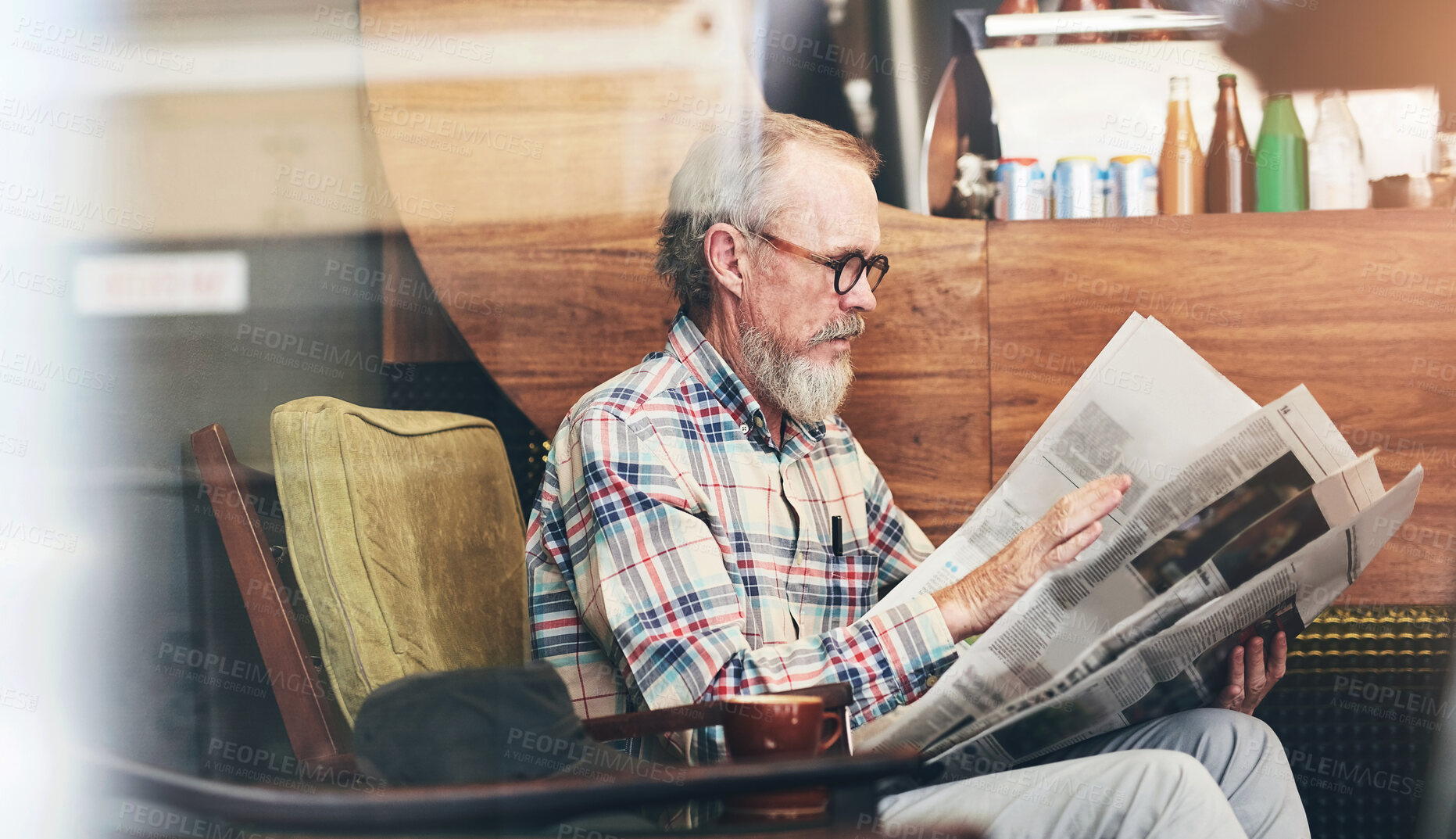 Buy stock photo Newspaper, cafe and senior man reading business information for financial stock market. Window, glasses and elderly male person enjoying economy headlines in journalism article in coffee shop.