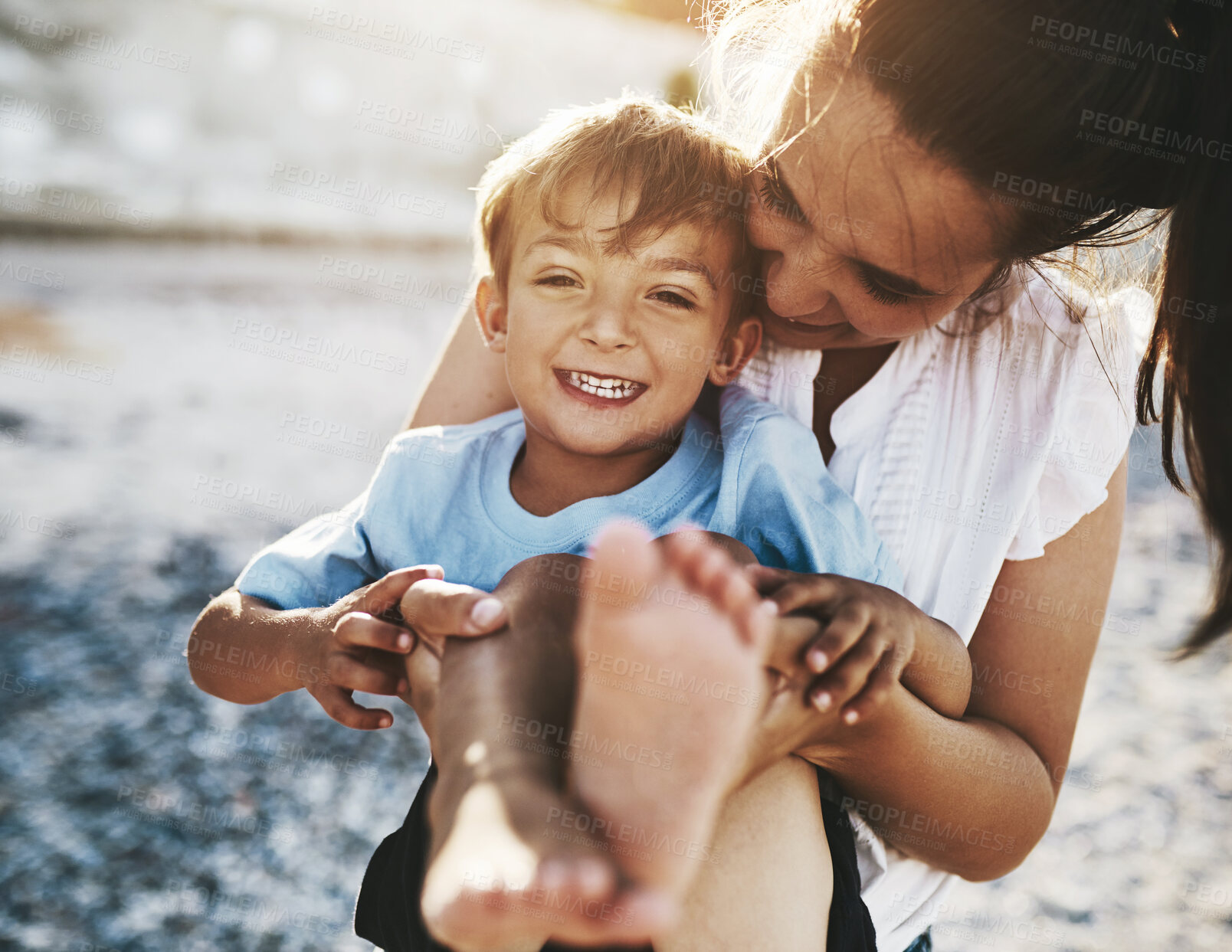 Buy stock photo Mom, child and beach fun with hug, playing and laughing by the sea with love, care and bonding. Vacation, holiday and travel outdoor with parent and boy by the ocean with smile and trip together