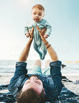 Buy stock photo Beach, sand and man with lifting baby on towel for summer adventure, bonding and child development. Family, vacation and dad with infant by ocean for fathers day, love and outdoor holiday in Florida