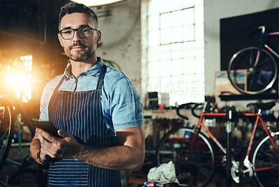 Buy stock photo Bicycle, portrait and phone for man, small business or garage of mechanic, engineer or entrepreneur. Proud, owner or person with service maintenance for bike, repair or transport with mobile app