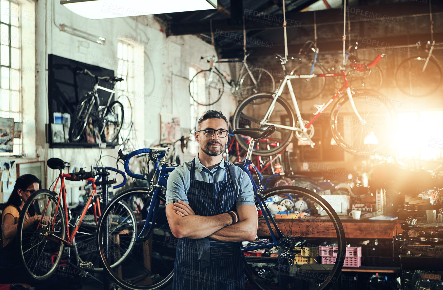 Buy stock photo Mechanic, portrait and arms crossed at work in bike repair shop or maintenance garage. Bicycle, man and service with a professional handyman for startup, small business and workshop for fixing