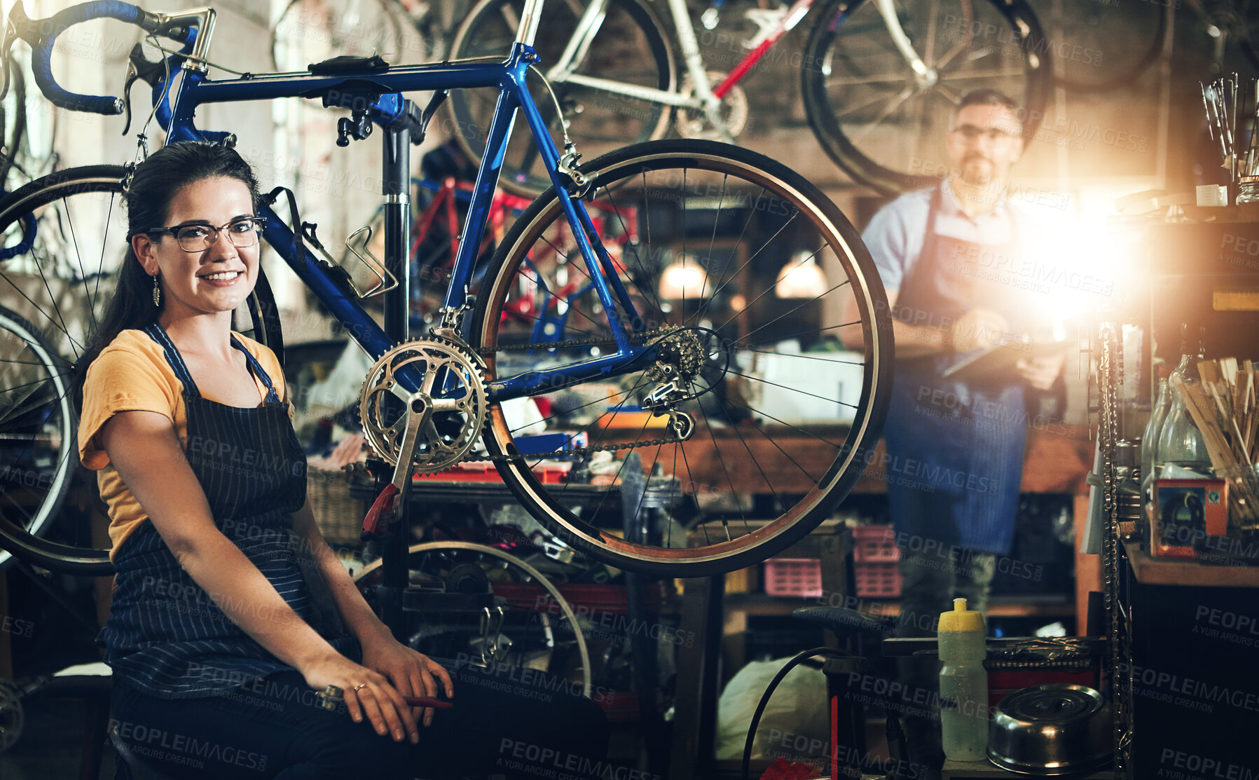 Buy stock photo People, portrait and bicycle mechanic with teamwork for inspection, maintenance or small business at repair shop. Man, woman or cycling engineers working on bike with tools or equipment at workshop