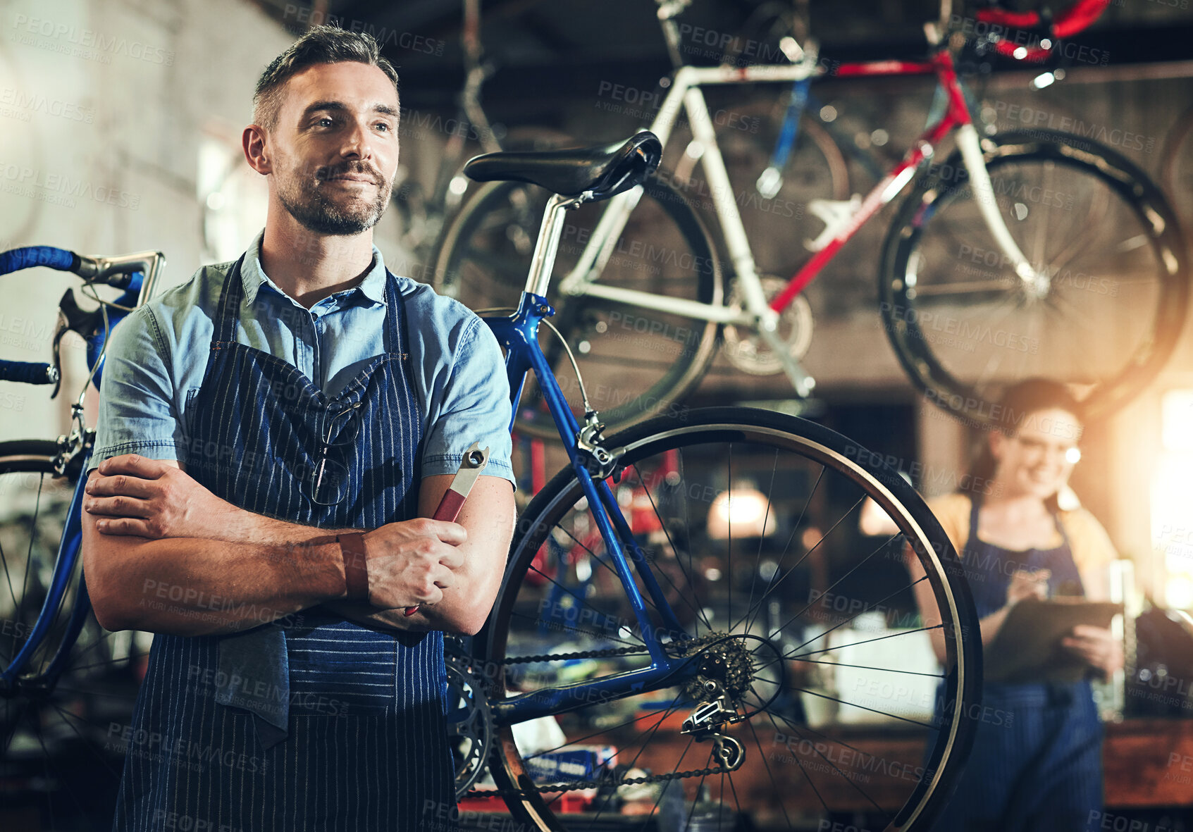 Buy stock photo Man, bicycle mechanic and professional with confidence in small business for fix, repair or maintenance. Confident male person, cycle technician or bike engineer with tool or equipment at workshop
