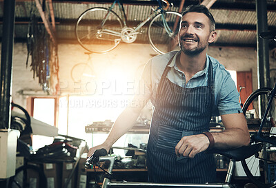 Buy stock photo Happy, man and bicycle repair shop with mechanic, technician and maintenance work with pride. Workshop, service and business owner with startup, apron and bike for fixing with entrepreneur in garage