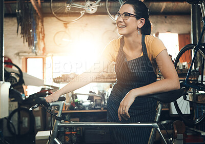 Buy stock photo Woman, bicycle shop and thinking for maintenance work, startup with transport service. Bike, mechanic and female entrepreneur in workshop with idea, thoughtful for sustainable business with happiness