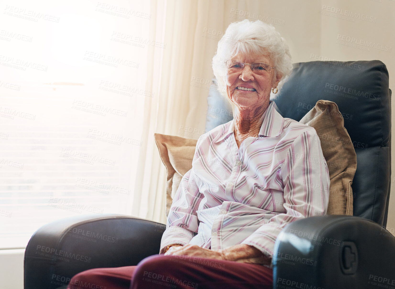 Buy stock photo Happy, portrait and senior woman relax on a chair in nursing home with security, safety and elderly care confidence. Smile, face and calm old lady person in peaceful retirement house living room 