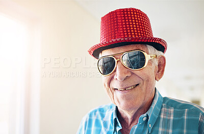 Buy stock photo Face, smile and sunglasses with senior man in living room of retirement home for dress up on weekend. Portrait, unique style and eyewear with happy mature person with hat in elder care apartment