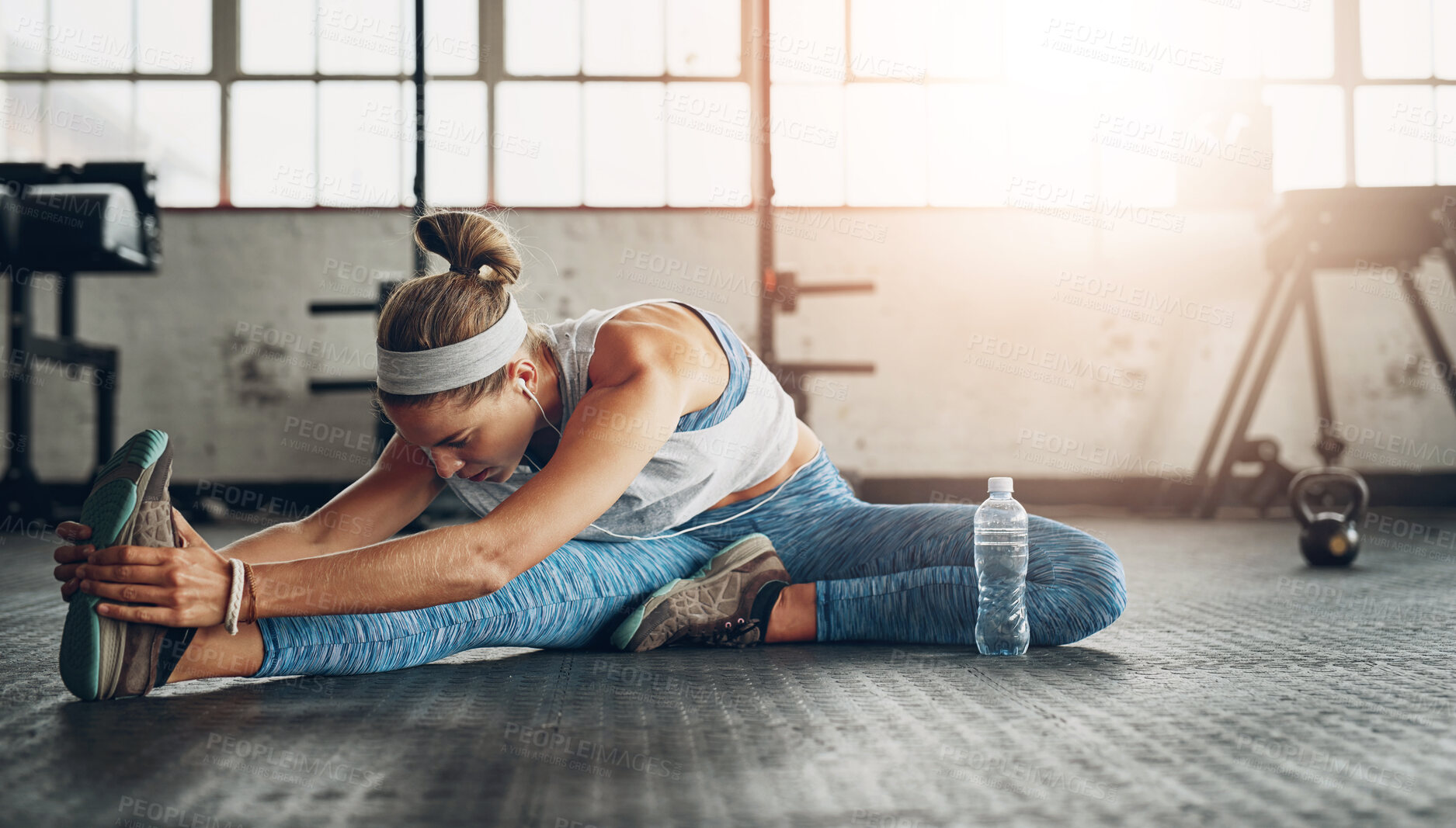 Buy stock photo Fitness, legs and stretching with woman on floor of gym for health, improvement or wellness. Exercise, training and warm up for workout with athlete getting ready for physical improvement routine