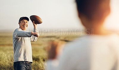 Buy stock photo Kid, dad and throw with football on grass field for outdoor sports, exercise and child development. Smile, man and happy with son in nature for teaching, practice and bonding together on fathers day