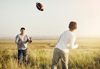 Buy stock photo Father, son or American football in outdoor for bonding, skills practice with dad in nature. Male person, boy child and development or training in countryside, together for exercise or learning sport