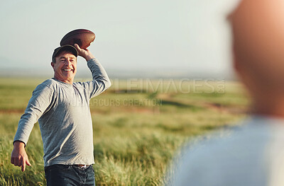 Buy stock photo Son, man and sports with football on grass field for outdoor exercise, teaching and child development. Happy, dad and smile with kid in nature for throw, practice and bonding together on fathers day