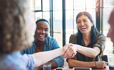 Buy stock photo Shaking hands, meeting and business people in office with deal, agreement or partnership. Smile, greeting and group of professional creative designers with handshake for onboarding welcome to team.