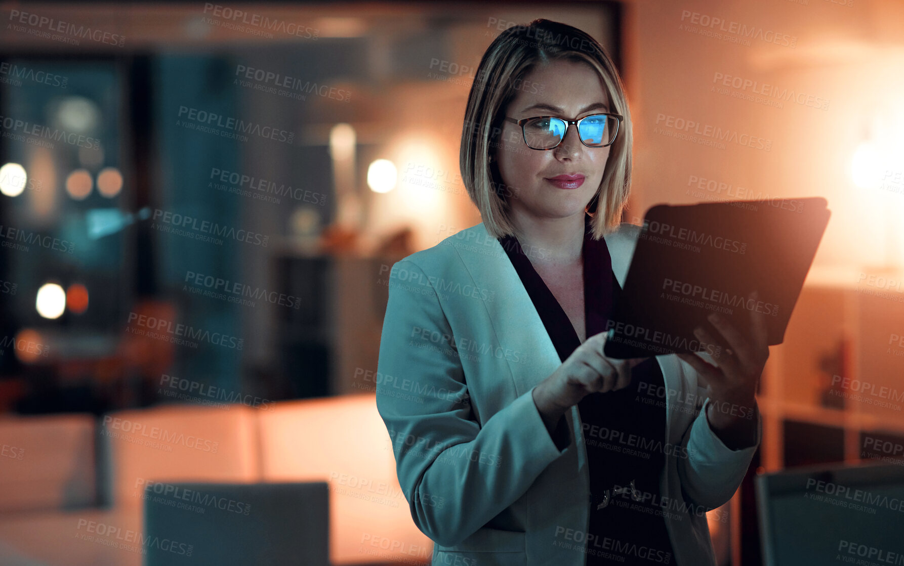 Buy stock photo Business woman, technology and working at night in office for company agenda, research and planning. Executive, tablet and reading email or report for corporate results, growth and revenue with data