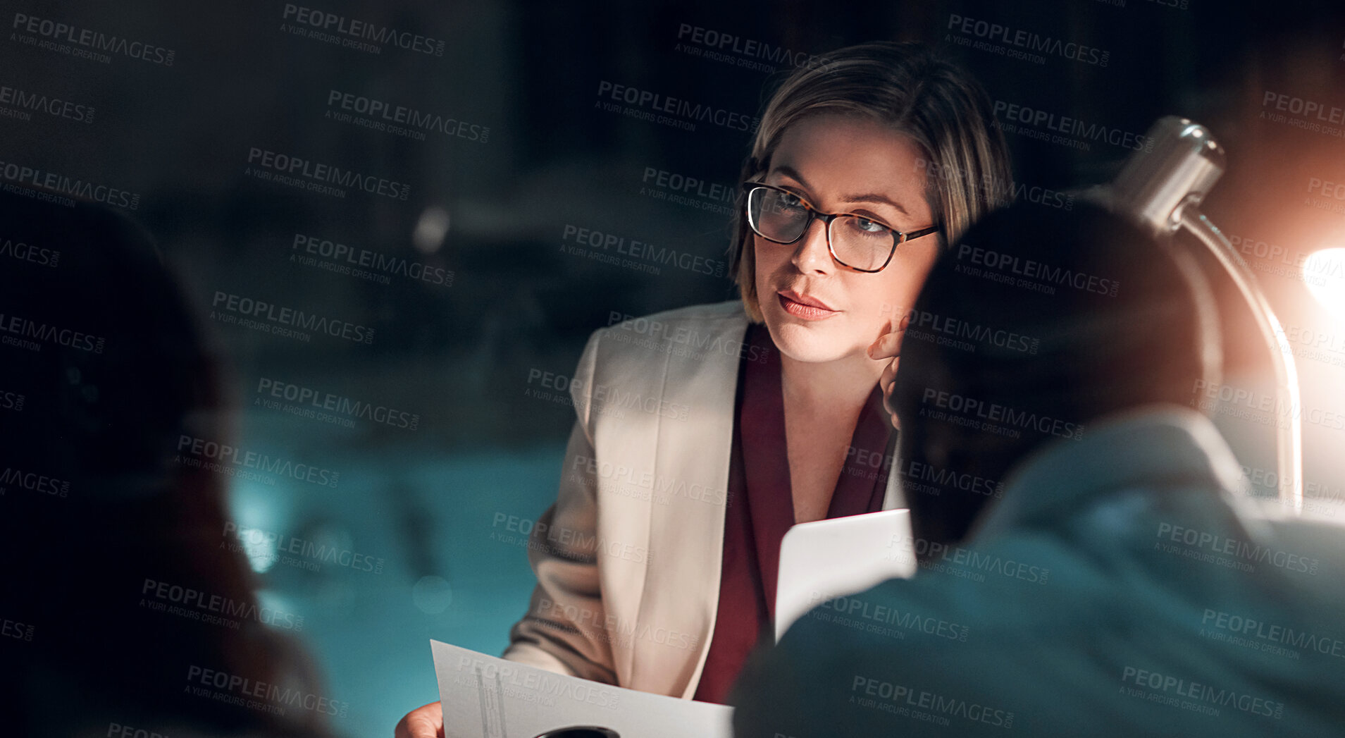 Buy stock photo Night, meeting and businesswoman in office with partner, documents and planning in corporate workplace. Female lawyer, legal team or overworked with staff for review, discussion or strategy for court