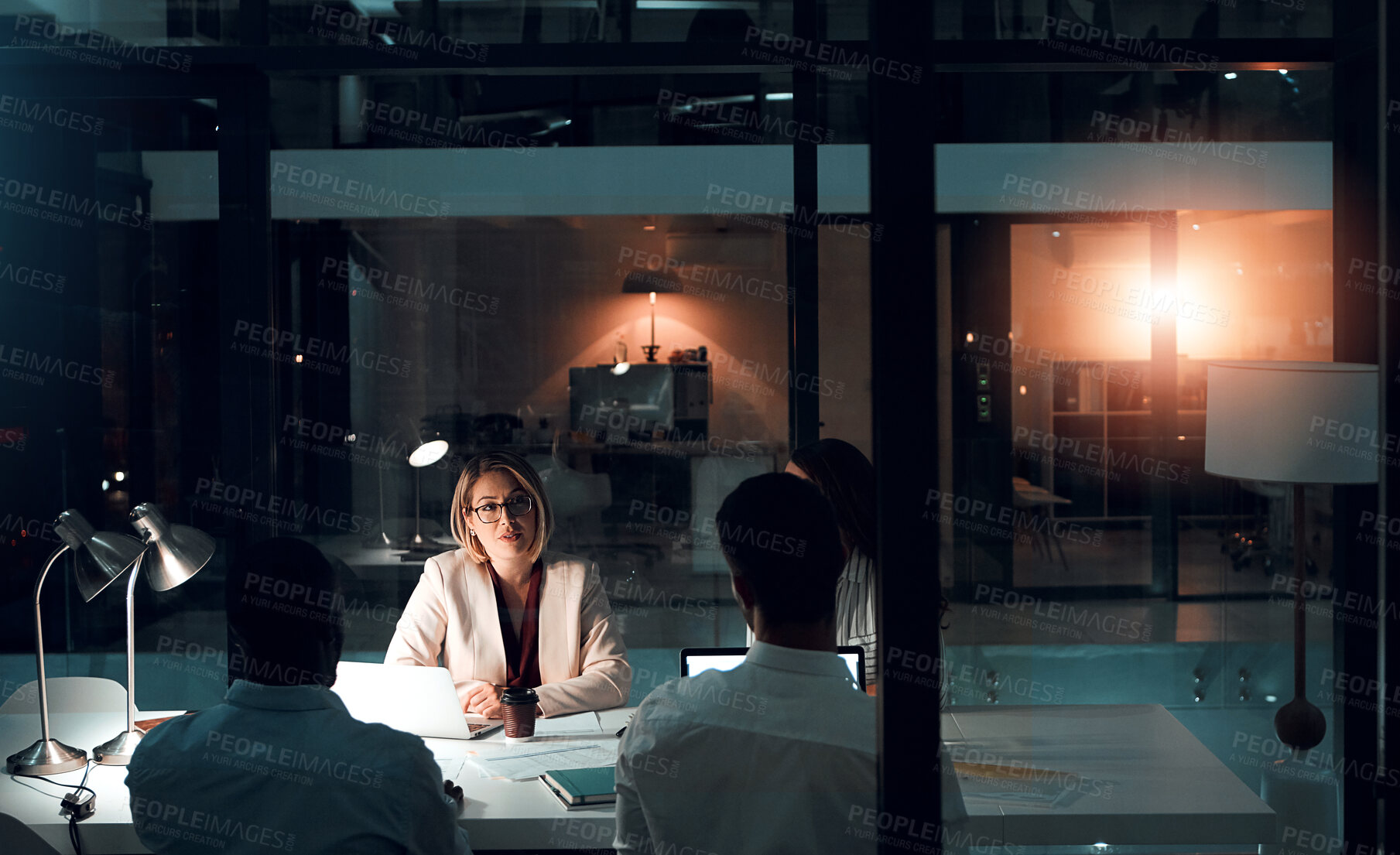 Buy stock photo Business woman, colleagues and laptop in office meeting for corporate communication, review or networking. Female person, tech and coworkers working late night for project planning or discussion