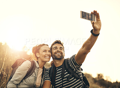 Buy stock photo Selfie, love and couple hiking in nature together for adventure, fun and sunset mountain exploration. Photograph, travel and man with woman bonding while smiling for profile picture on social media