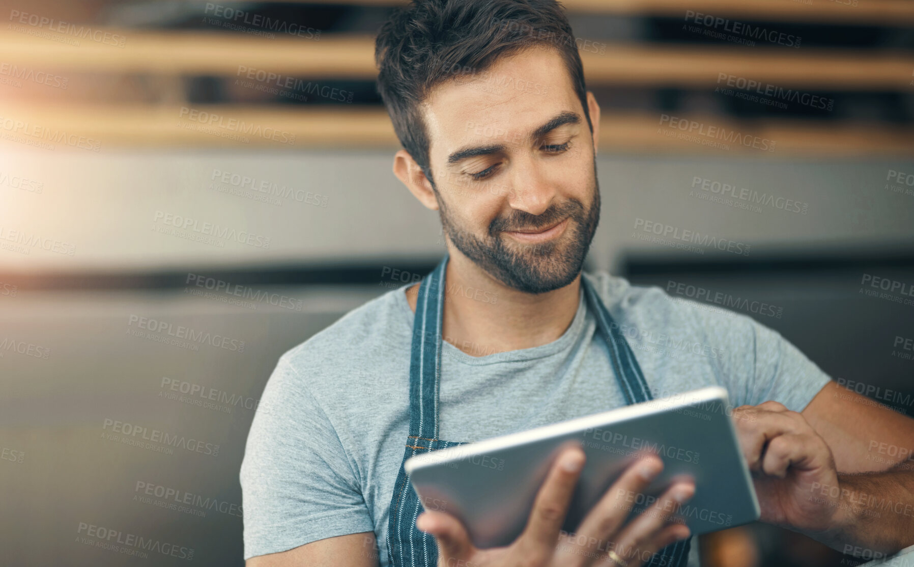 Buy stock photo Business, apron and man with tablet, typing and internet with digital app, barista and restaurant. Online order, person and entrepreneur with tech, schedule and waiter in cafe, network and service