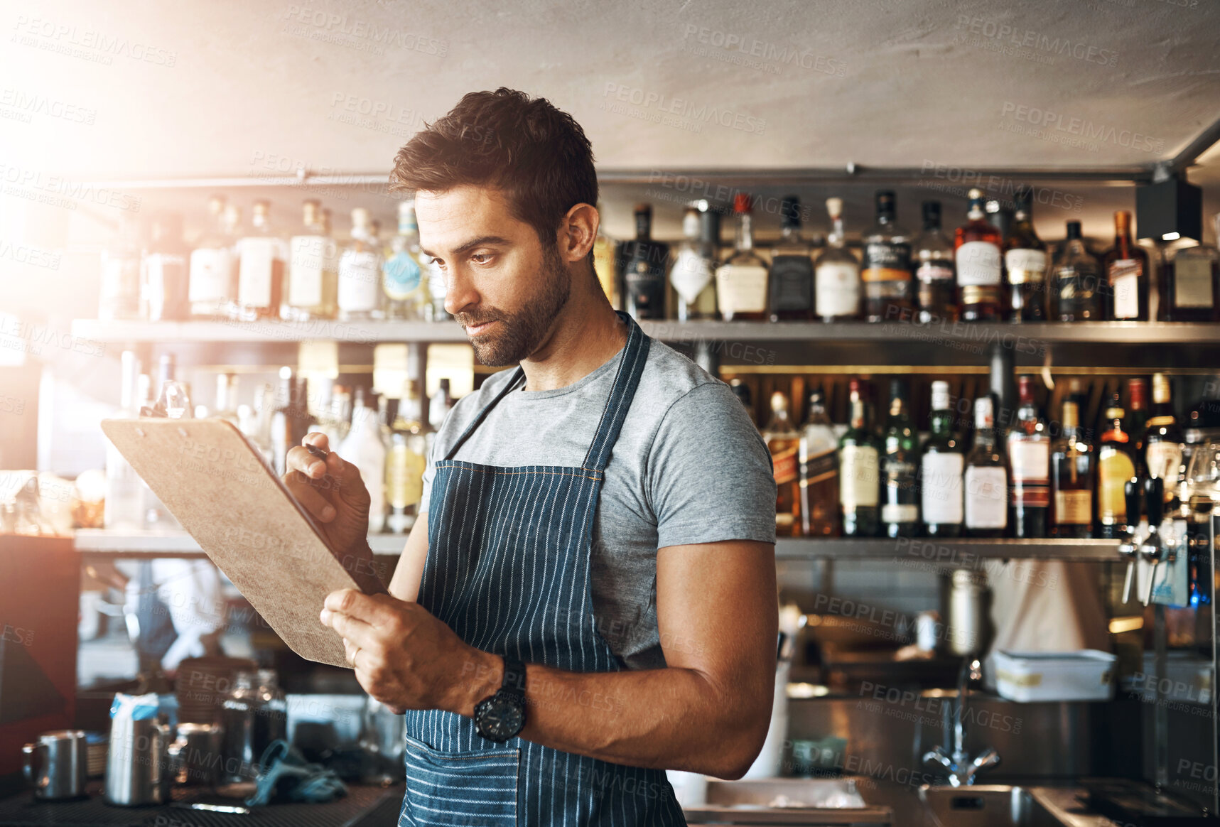 Buy stock photo Barman, writing and clipboard for restaurant management with stock, inventory or check for liquor. Man, bartender and checklist with thinking, order or inspection for alcohol, invoice or notes at pub