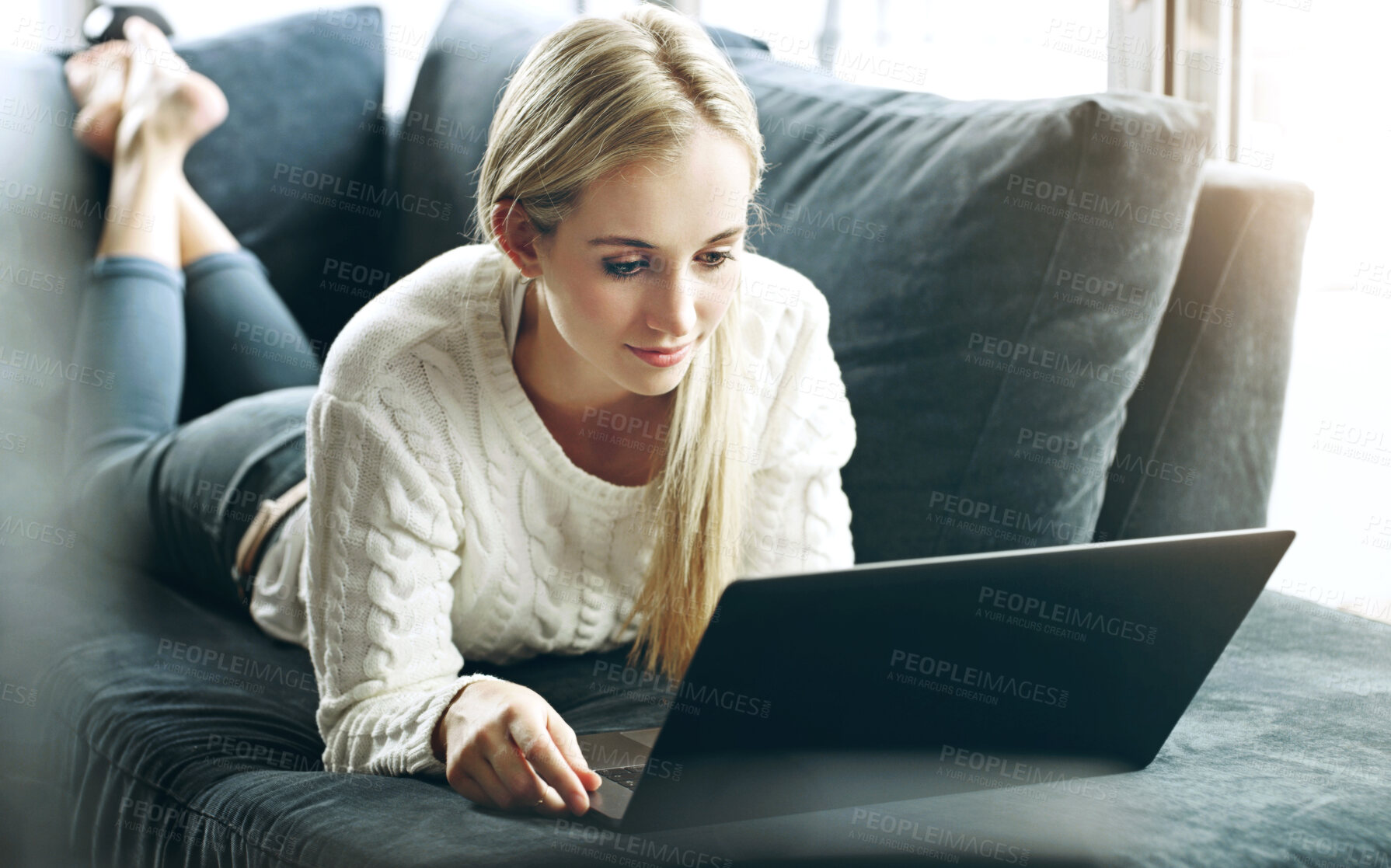 Buy stock photo Woman, laptop and relax on sofa in home with watching movie, social media scroll on internet browsing. Girl, person or technology on couch for subscription service, streaming series or reading ebook