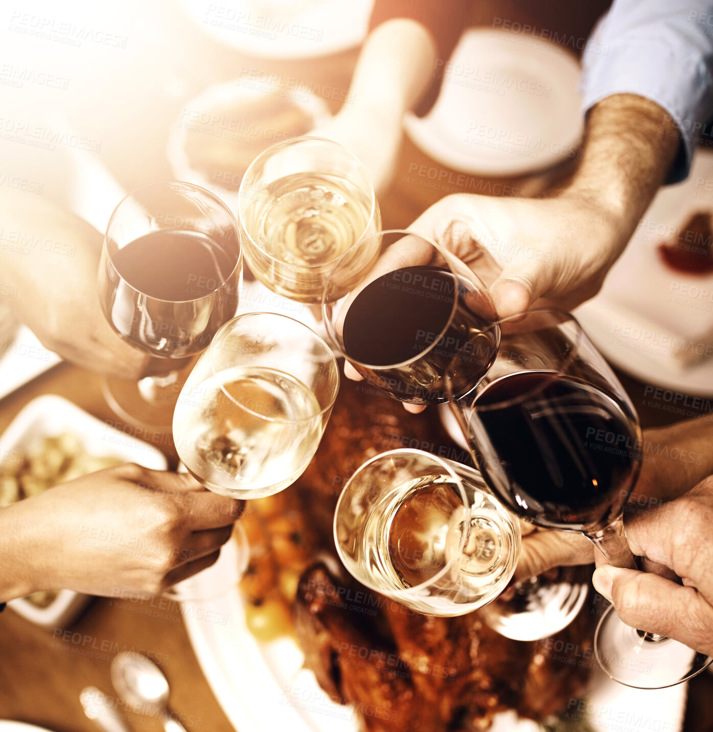 Buy stock photo Group, people and hands with wine for toast at Christmas dinner, turkey on table for holiday party. Crowd, alcohol and glass for vacation celebration with food in house, bonding together or wellness