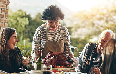 Buy stock photo American, thanksgiving and woman with turkey for dinner, lunch and serving food outdoor. Happy family, usa tradition and celebration as culture, express gratitude and reflect on blessings in garden