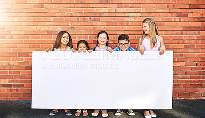 Buy stock photo Children, wall and outdoor with sign board in smile or fun for promotion and advertisement. People, gen z and happy with placard for instructions in portrait as friends with mockup for marketing