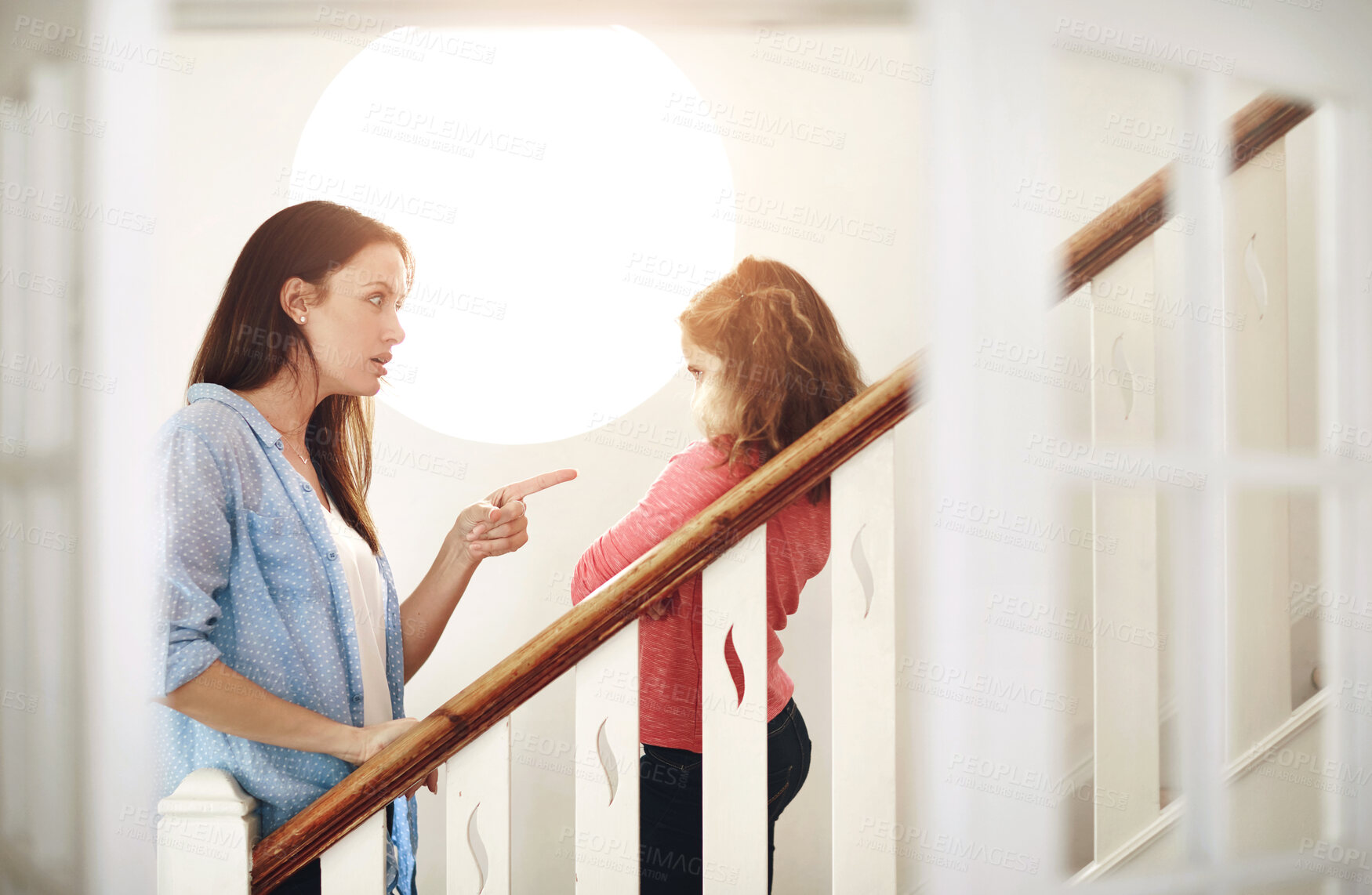Buy stock photo Mother, girl child and pointing for discipline on stairs, warning for mistake in home. Mama, daughter and finger sign for angry conversation in house, together with conflict or chat for development