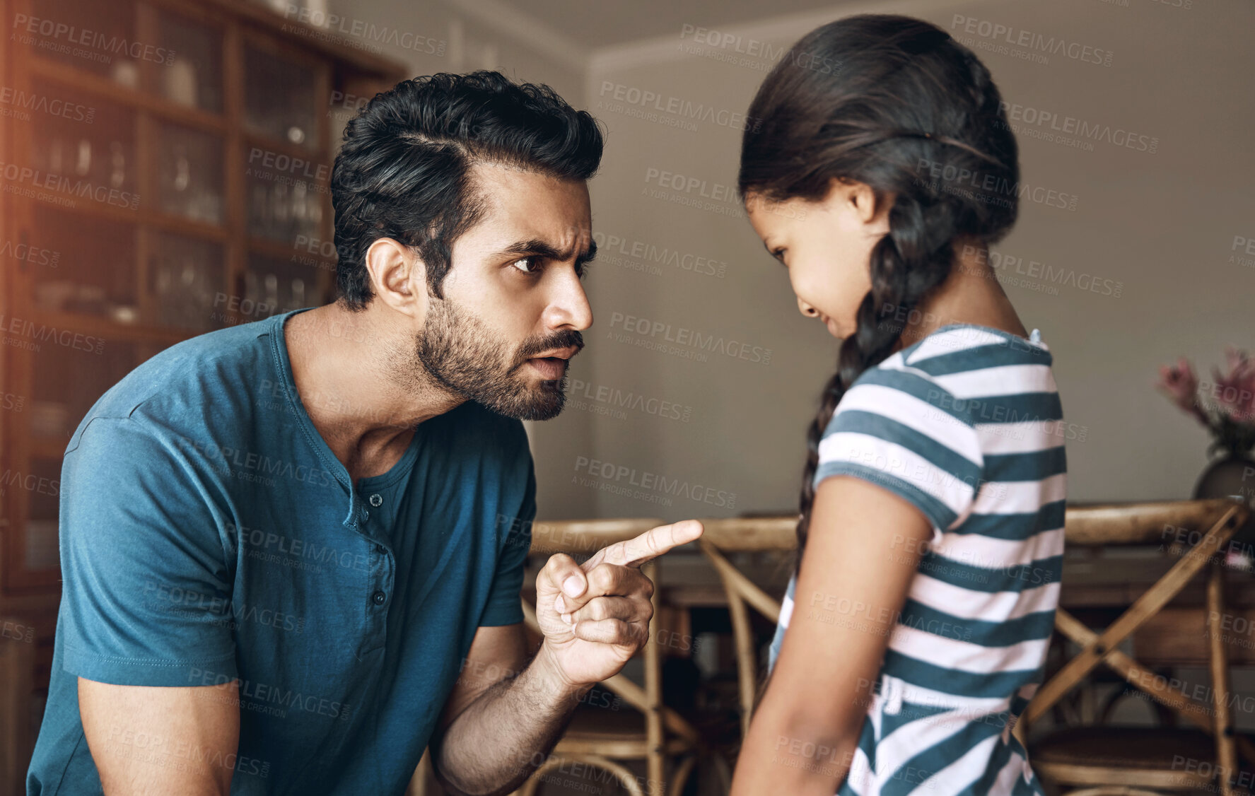 Buy stock photo Angry, father and kid with scolding in punishment for communication, behaviour and problem at home. Frustrated, man and parent with parenting of little girl for argument, trouble and discipline