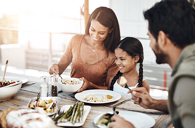 Buy stock photo Lunch, family and smile with mother, child and father together with healthy food and support. Vegetables, love and bonding of parents and young girl with happy, wellness and salad on home patio