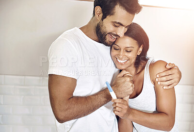 Buy stock photo Embrace, man and woman in bathroom with pregnancy test, smile and family planning in home. Good news, surprise results and pregnant couple in excited hug for health, wellness and happy in marriage