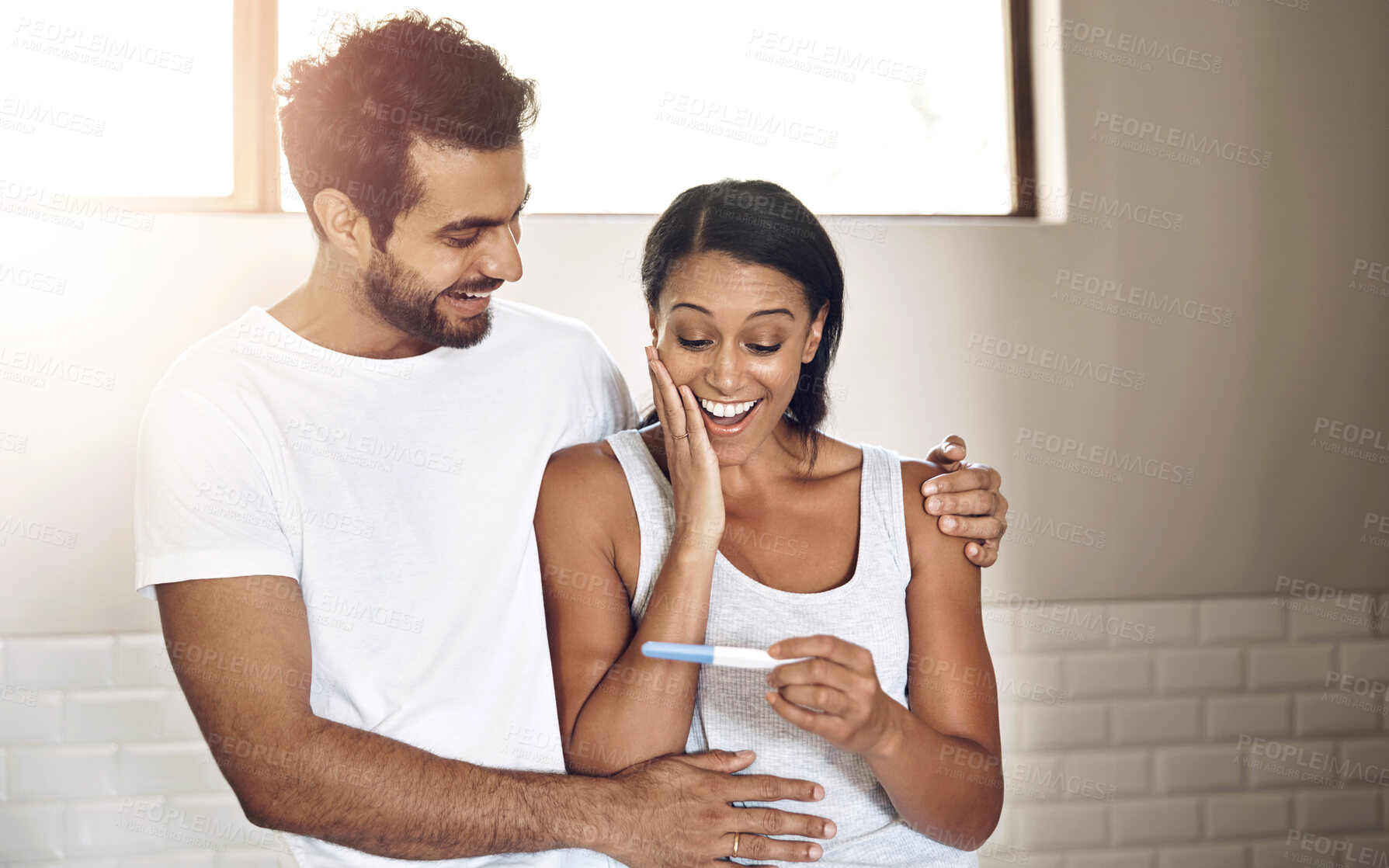 Buy stock photo Excited, man and woman in bathroom with pregnancy test, smile and family planning in home. Good news, surprise results and pregnant couple with celebration of health, wellness and happy in marriage.