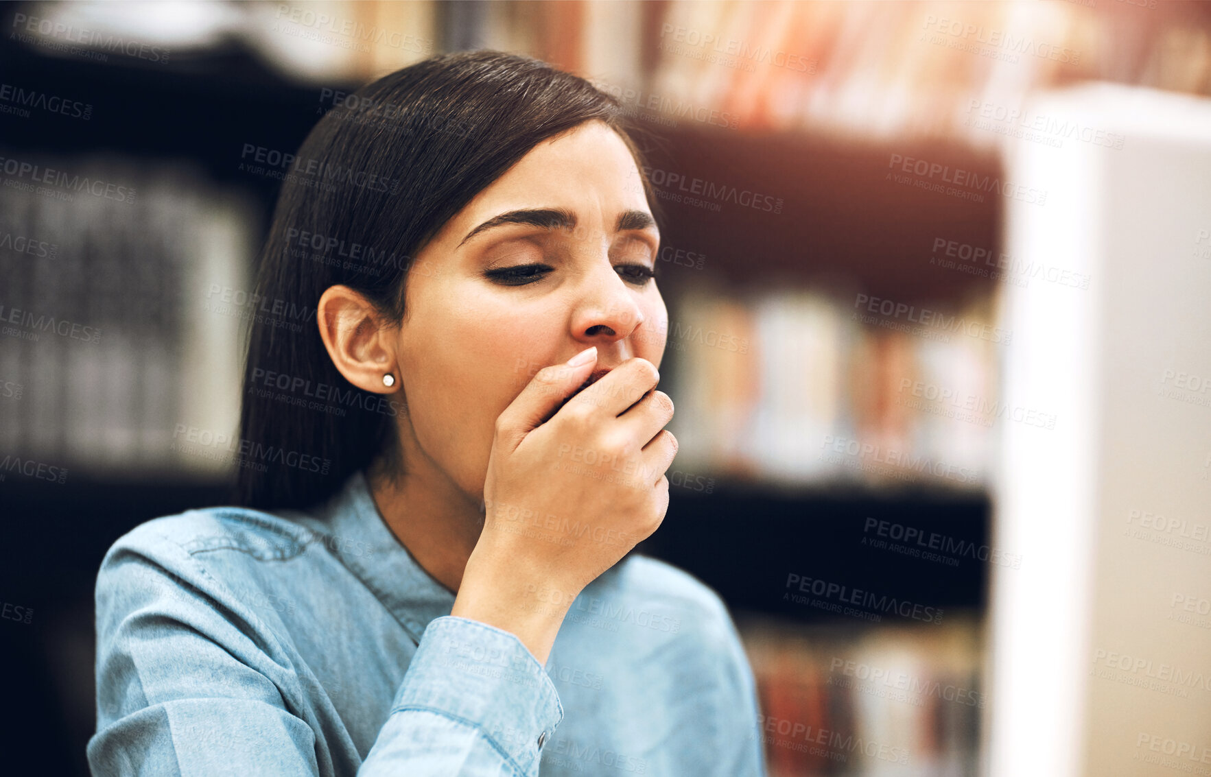 Buy stock photo Tired, student and woman in library, yawning and exhausted with deadline, overworked and burnout. Education, university and girl with fatigue, stress and studying for exams, sleepy and research