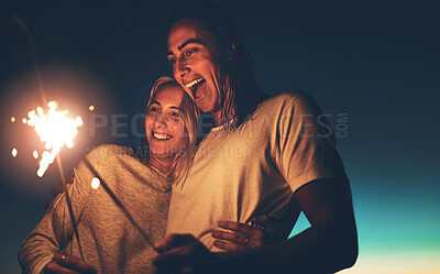 Buy stock photo Night, sparkler and couple with hug for love, romance and healthy relationship with trust and happiness. Firecracker, happy man and woman with smile for celebrate anniversary together in dark outdoor