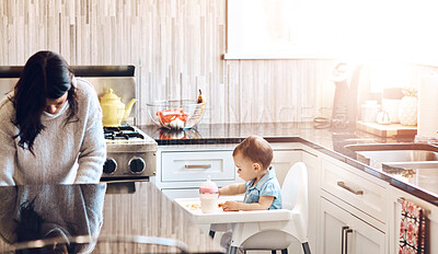 Buy stock photo Kitchen, mom and baby in high chair on day off in home with playing and busy with house keeping. Parent, woman and toddler for child development or growth with care, support and trust or bonding