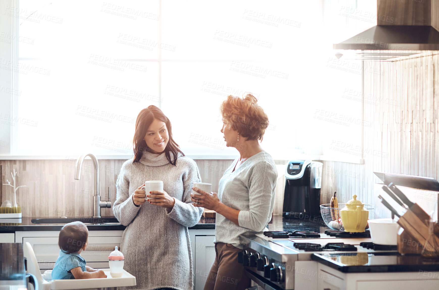 Buy stock photo Mom, grandmother and baby in kitchen for love, support and coffee in family home. Women, talking and together in house for childcare, security and protection with toddler for visit or bonding