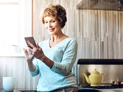 Buy stock photo Phone, smile and senior woman in kitchen with smile, connection or scroll on social media. Morning, relax and happy elderly person in home with smartphone, online chat or mobile app for communication