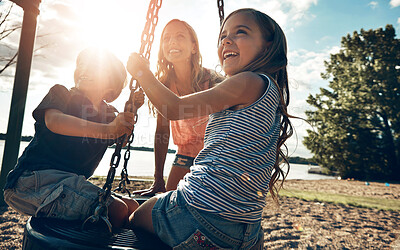 Buy stock photo Playground, swing and sunshine with mother, kids and excited with happiness, vacation and bonding together. Family, single parent and mama with son, daughter and childhood with swing, games or summer