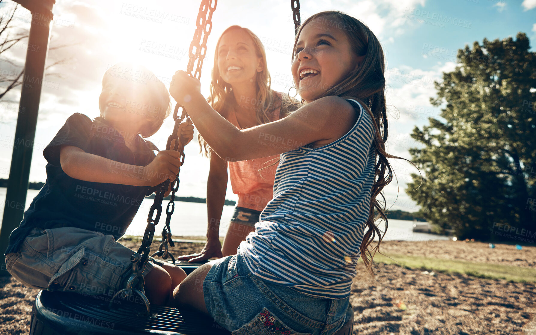 Buy stock photo Playground, swing and sunshine with mother, kids and excited with happiness, vacation and bonding together. Family, single parent and mama with son, daughter and childhood with swing, games or summer