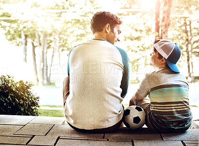 Buy stock photo Dad, kid and relax with soccer ball in backyard for outdoor sports, bonding and child development. Back, man and son outside home with smile for exercise, practice and happiness on fathers day