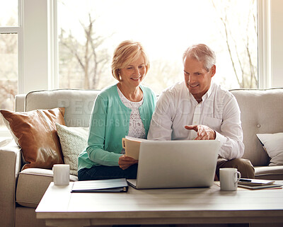 Buy stock photo Senior couple, documents and laptop on sofa with discussion, smile and manage taxes in home. Old man, woman and computer with paperwork for compliance, reading and investment report with finance